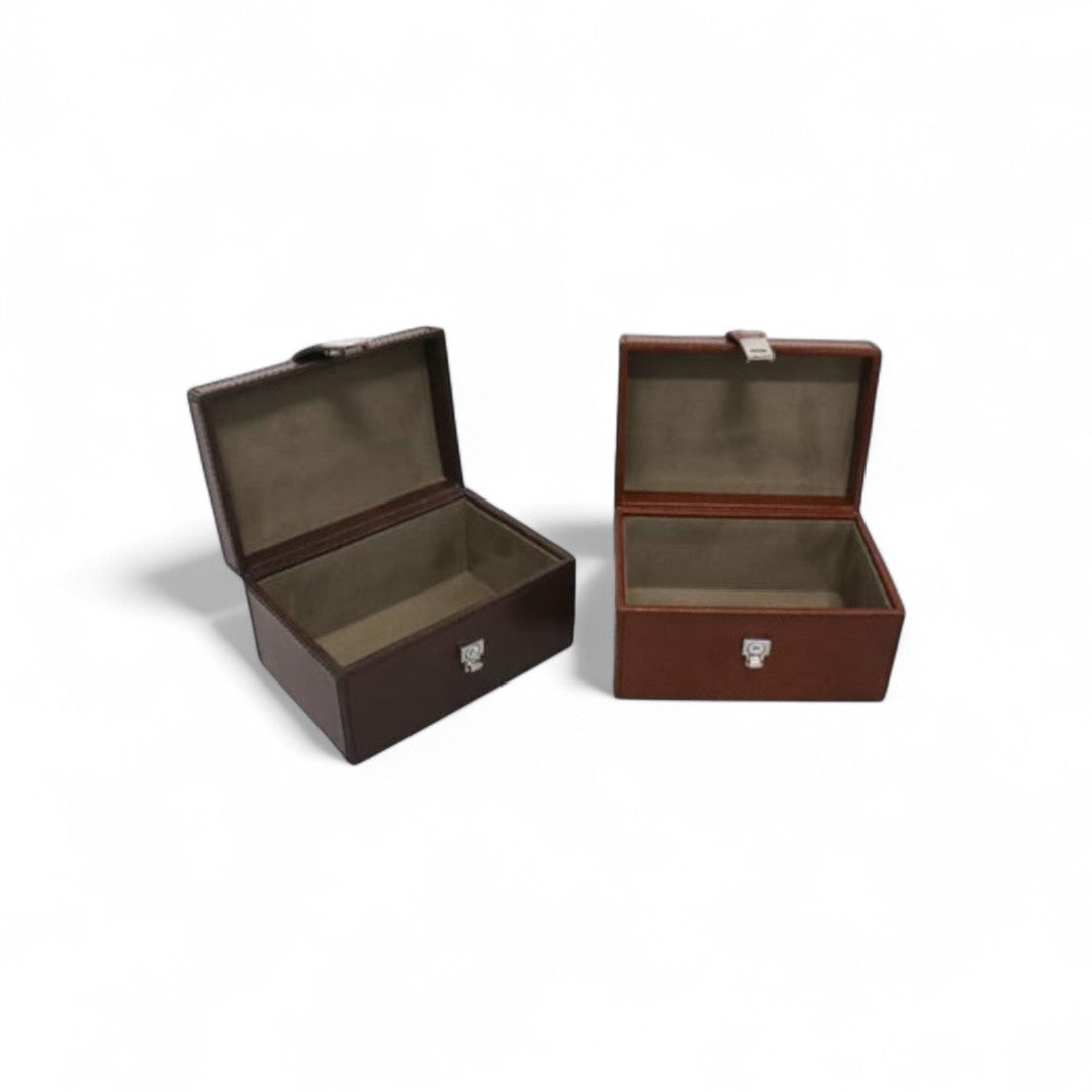 Two brown leather boxes with a visible brand logo on a white background