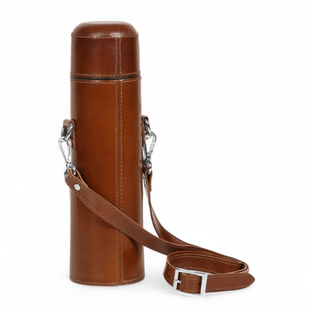 Brown leather cylindrical bag with a strap on a white background