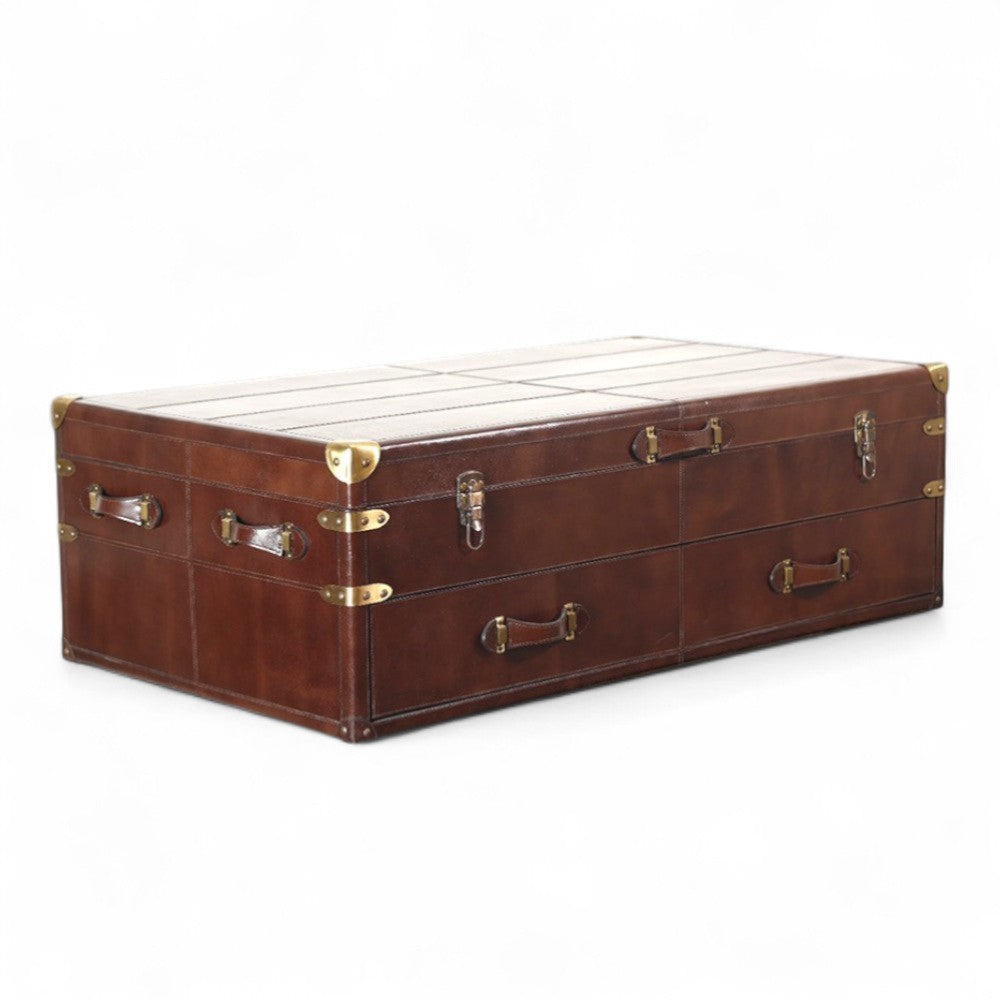 Brown leather trunk with brass hardware on a white background- center table