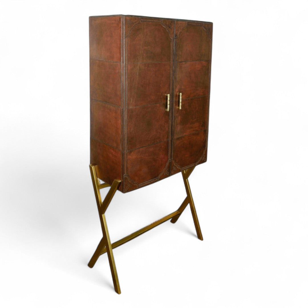 Brown leather cabinet with gold legs on a white background