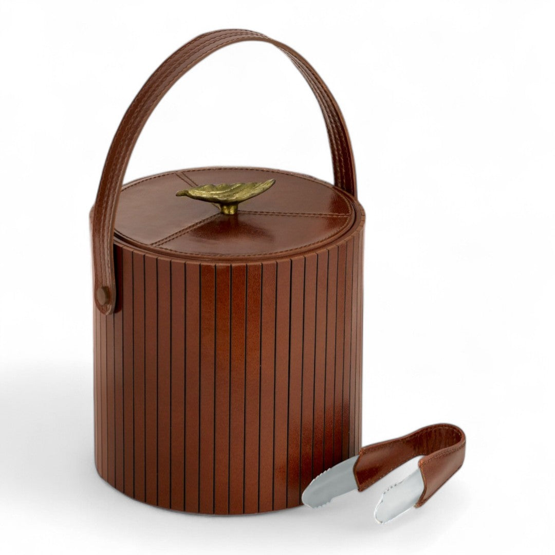 Brown leather ice bucket with handle and silver lid lifter on a white background