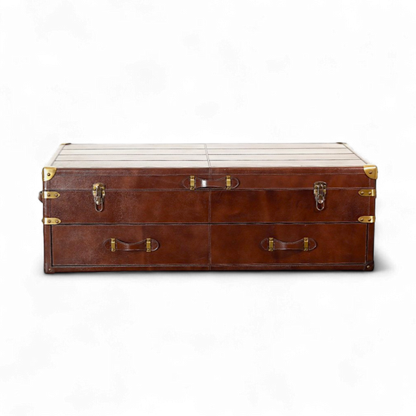 Brown leather trunk center table with gold hardware on a white background