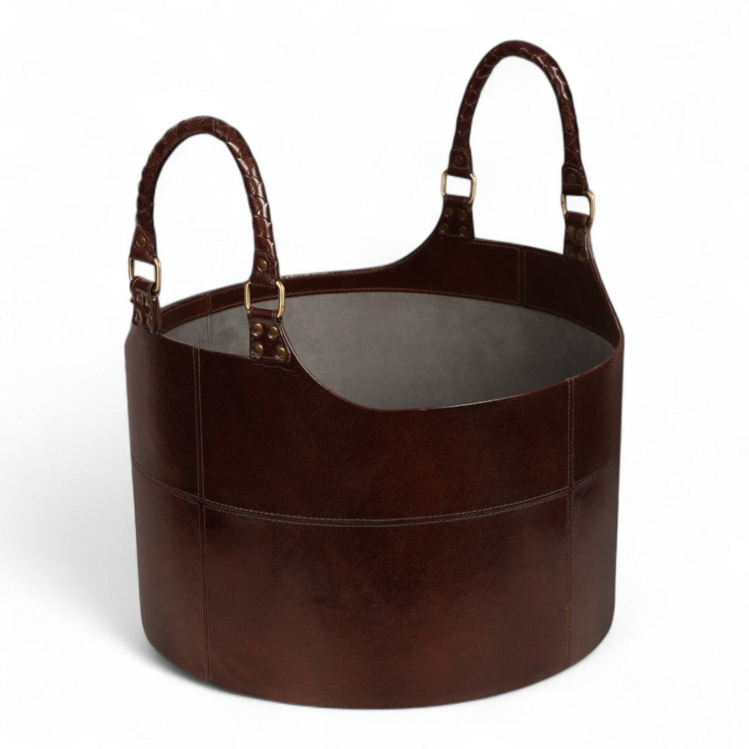 Brown leather basket with handles on a white background