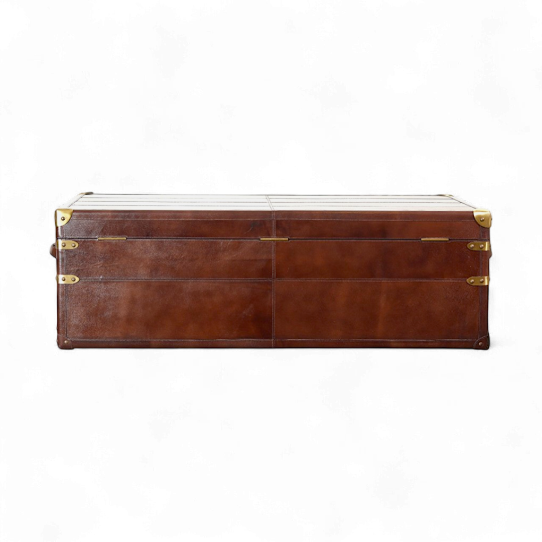 Brown leather trunk with gold hardware on a white background