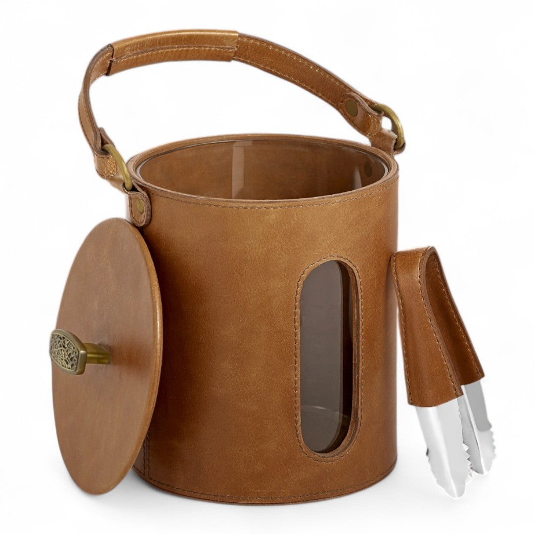 Brown leather ice bucket with a lid and utensils on a white background