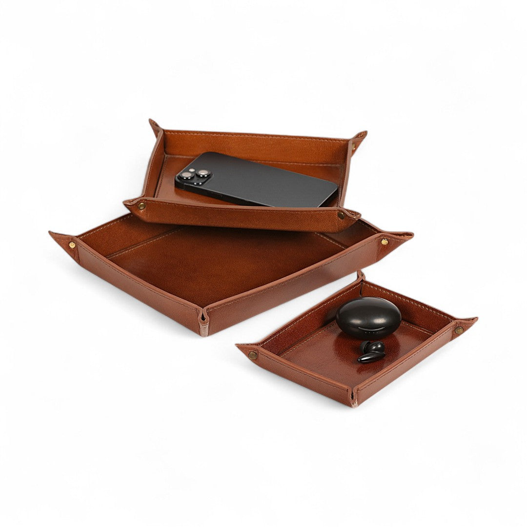 Brown leather tray set with compartments on a white background