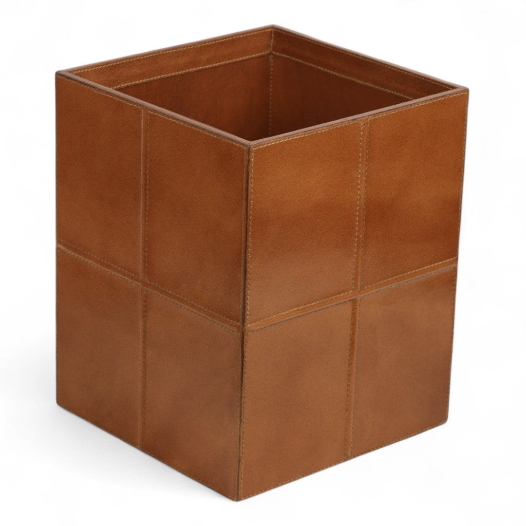 Tan leather wastebasket on a white background