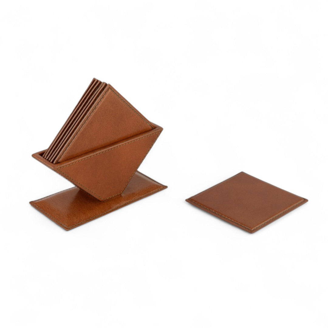 Set of brown leather coasters with a holder on a white background