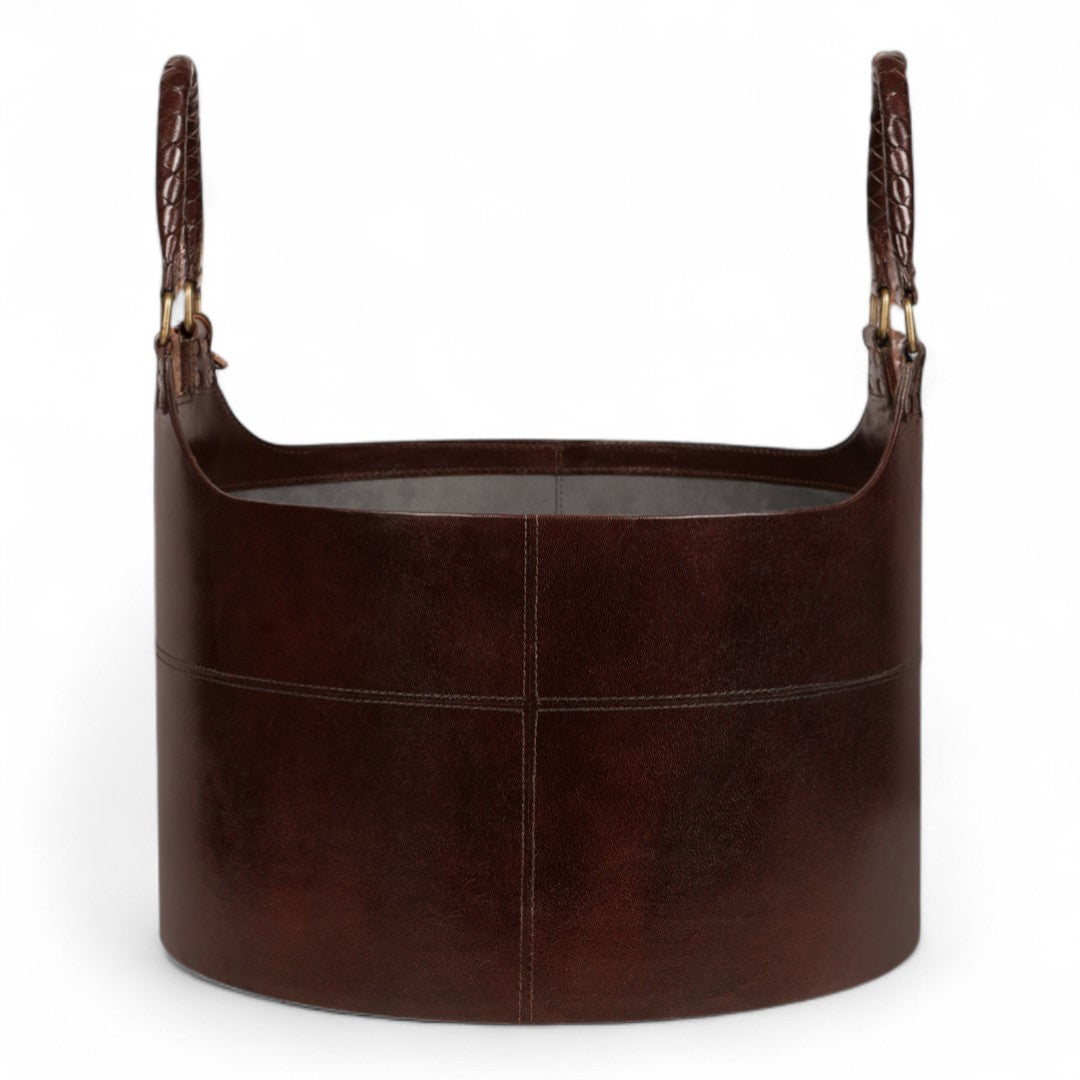 Brown leather basket with handles on a white background