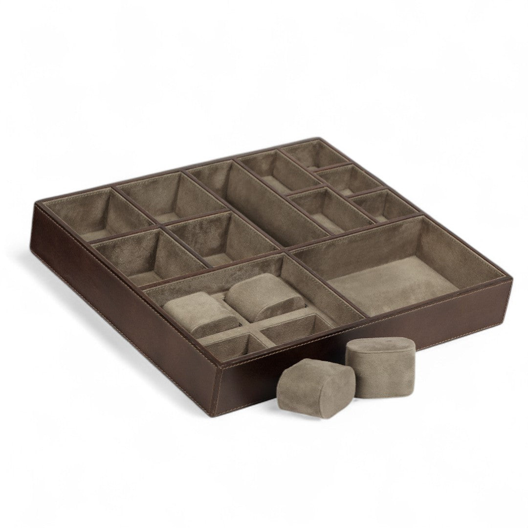 Brown jewelry display tray with compartments on a white background