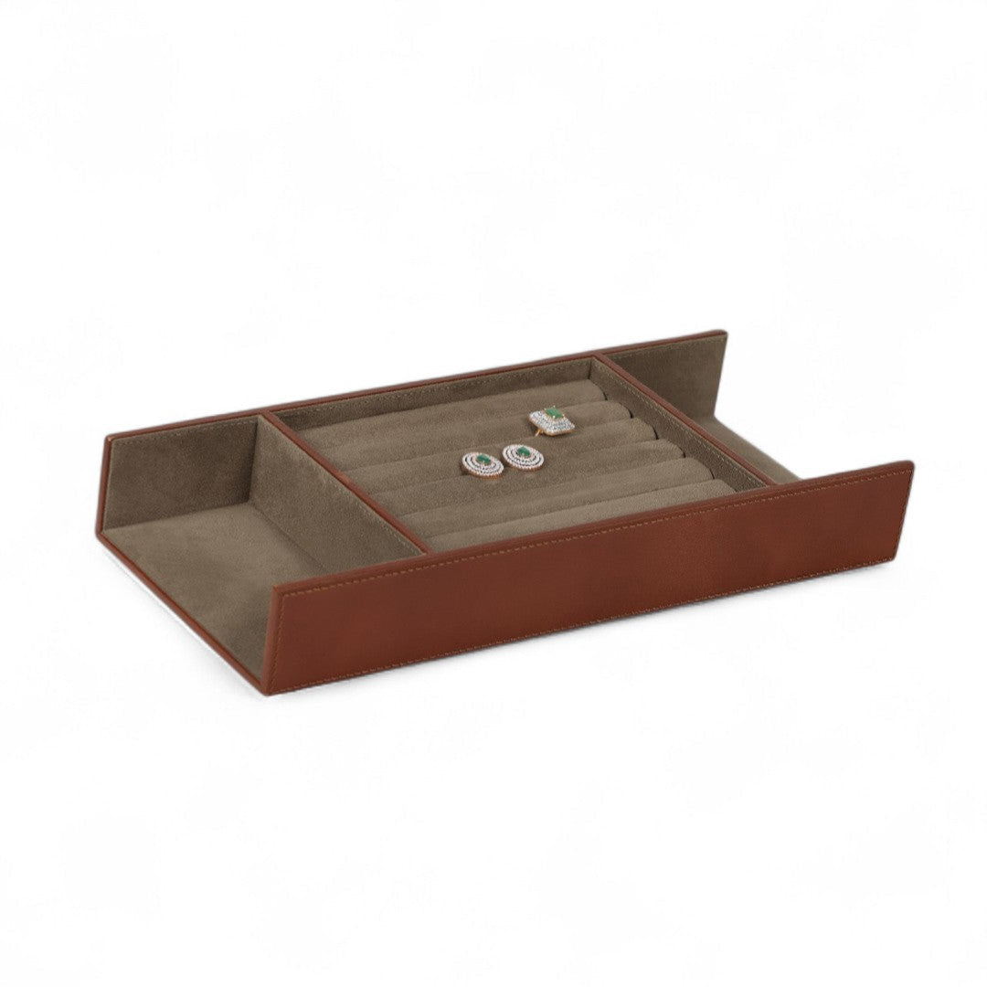Brown jewelry tray with a beige interior on a white background