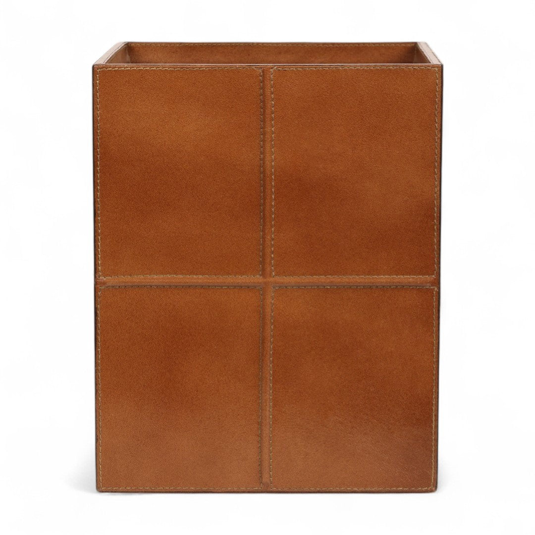 Tan leather wastebasket on a white background