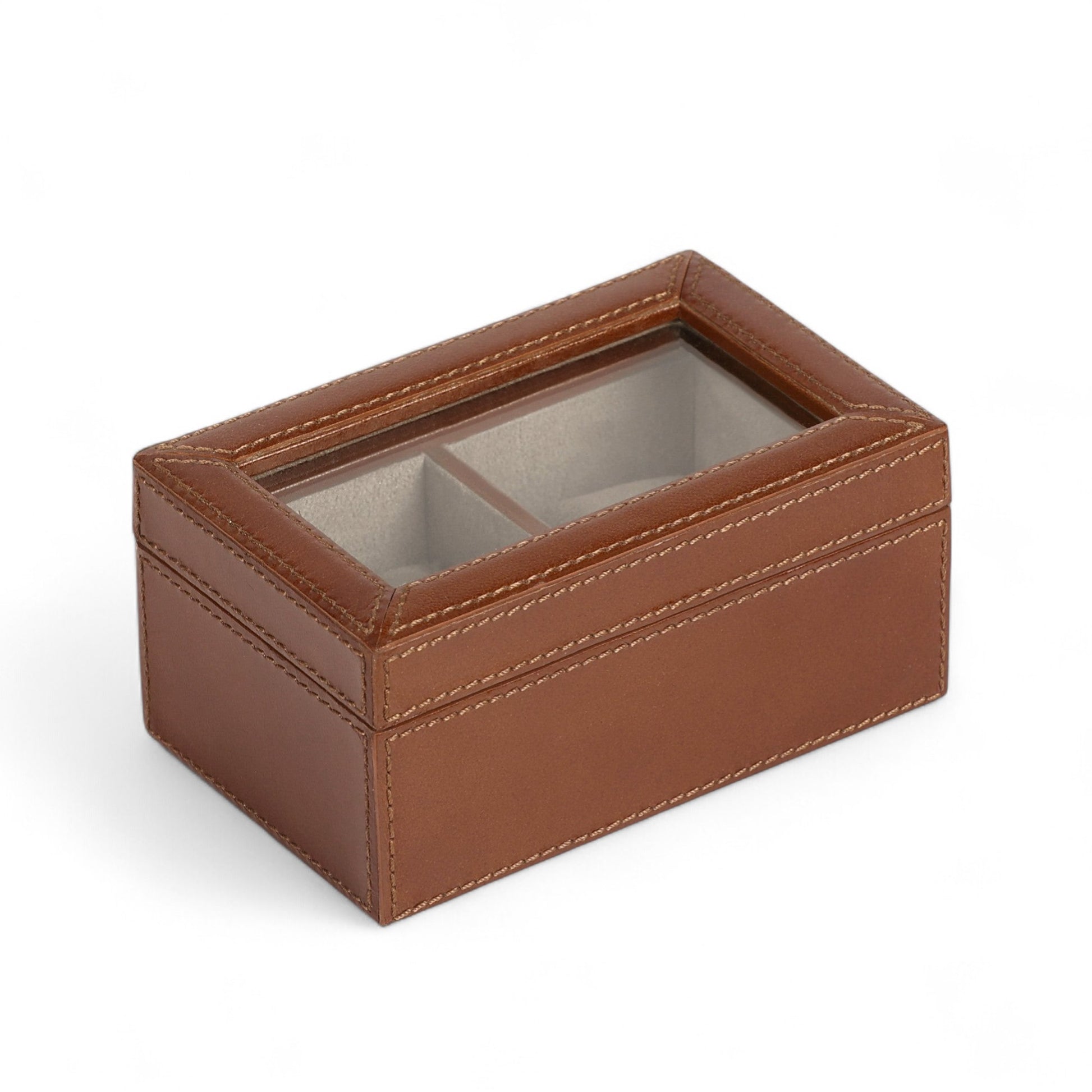Brown leather jewelry box with glass lid on a white background