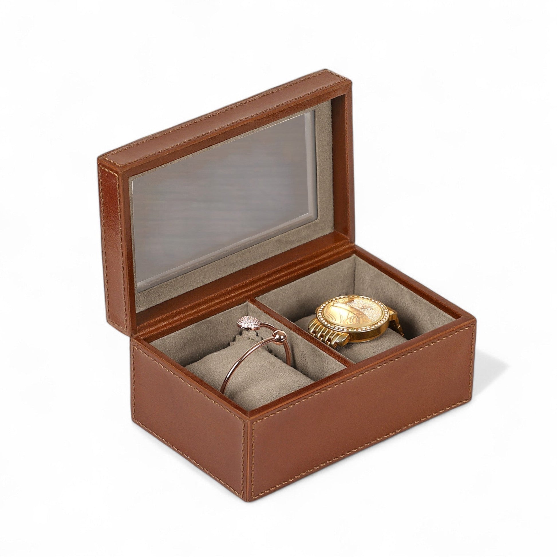 Brown jewelry box with a watch and ring inside on a white background