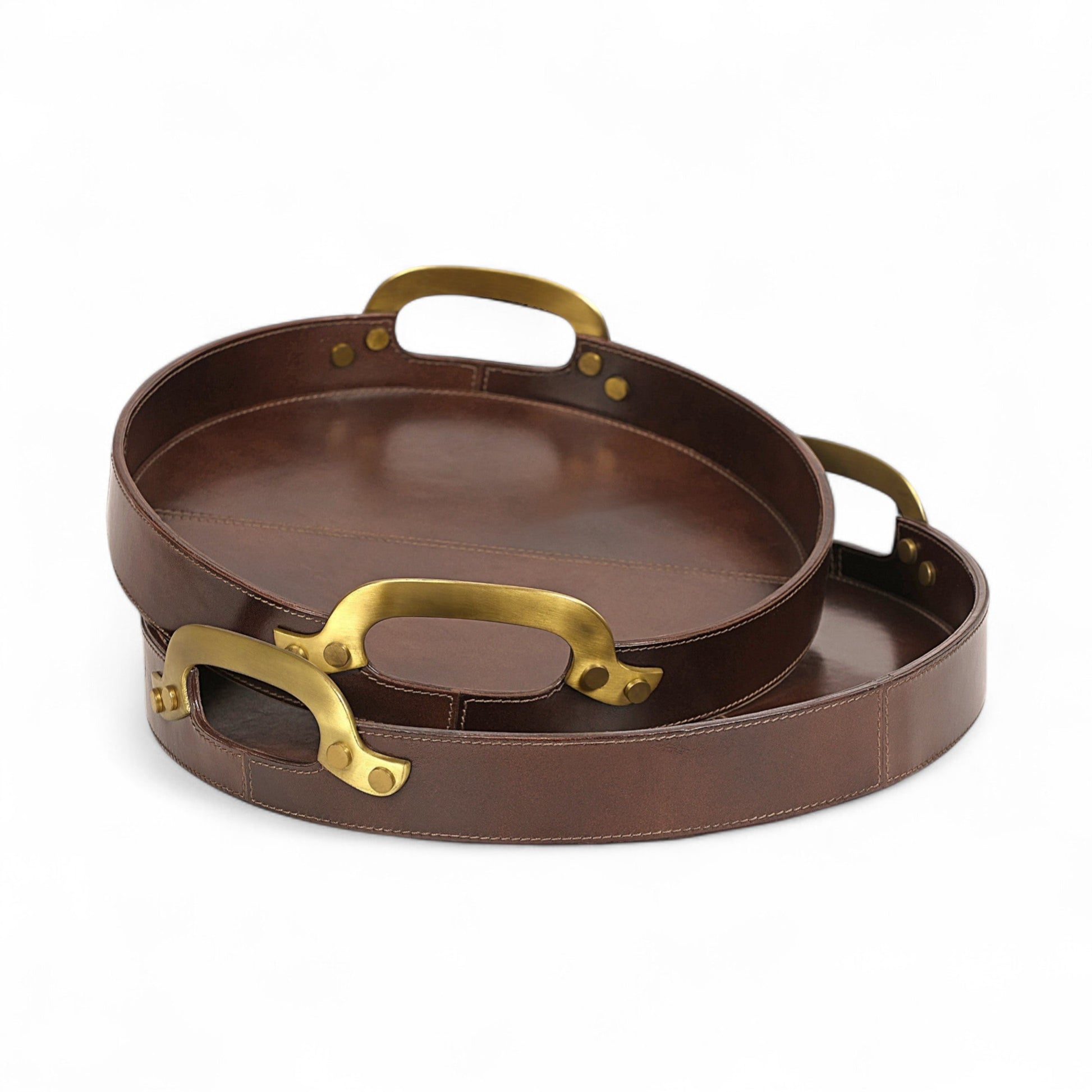 Two brown leather trays with gold handles on a white background