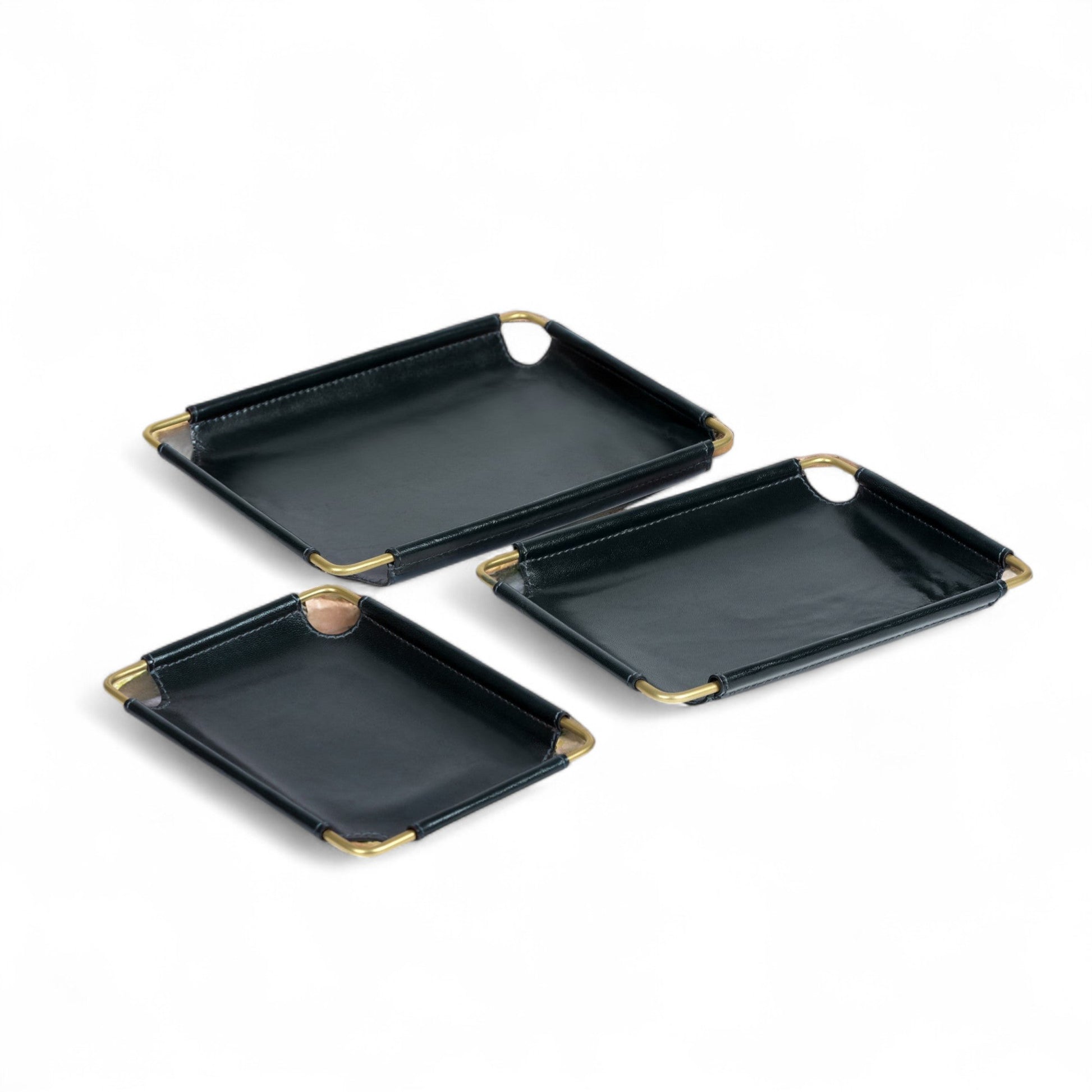Set of three dark blue trays with gold edges on a white background