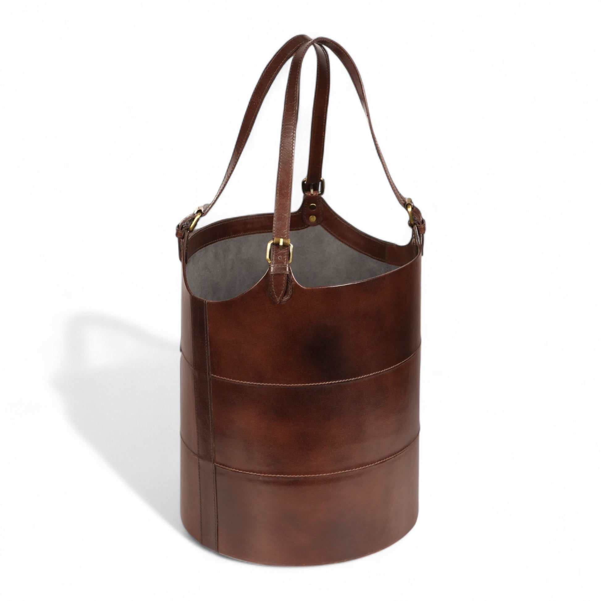 Brown leather bucket bag with a handle on a white background