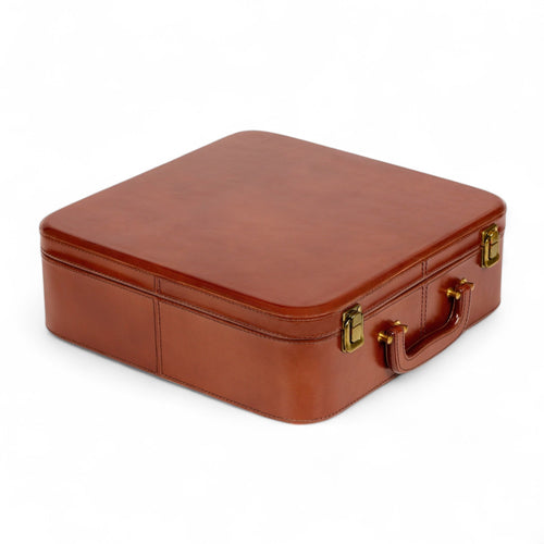 Brown leather suitcase with gold hardware on a white background