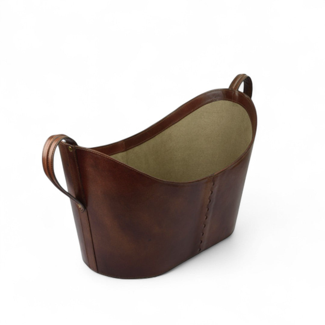 Brown leather basket with beige interior on a white background
